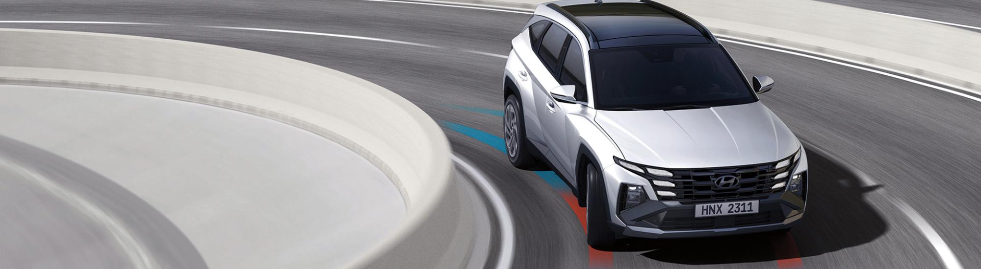 Hyundai Tucson Hybrid driving on a clean modern backdrop